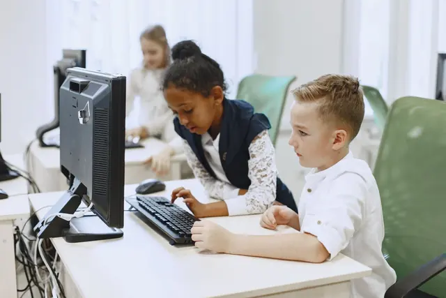 Pupils working on desktop computers in a computer lab