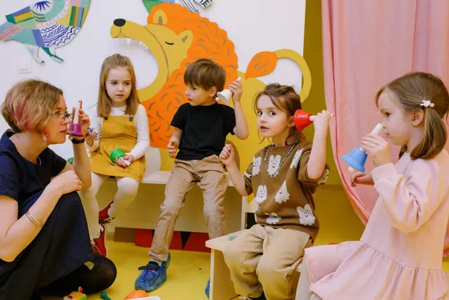 Young children with a teacher during a lively music class