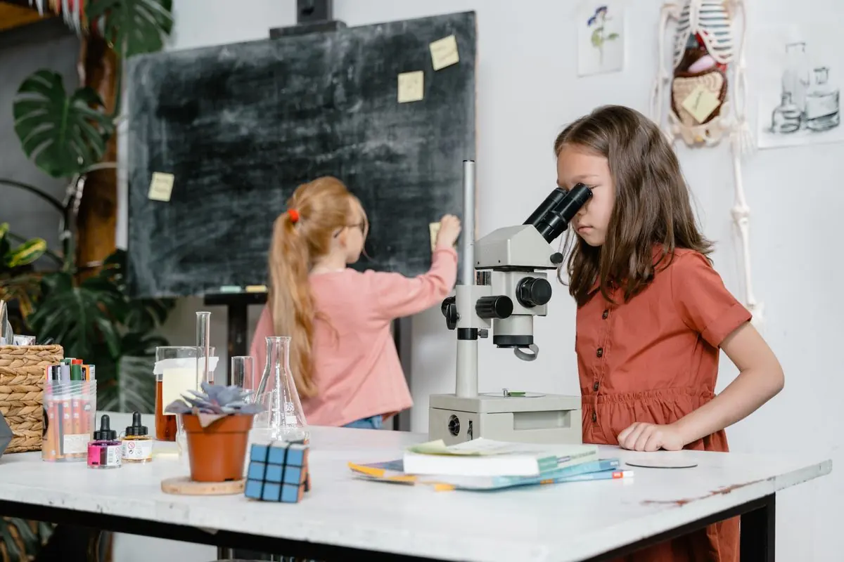 Two pupils looking through a microscope in a science classroom