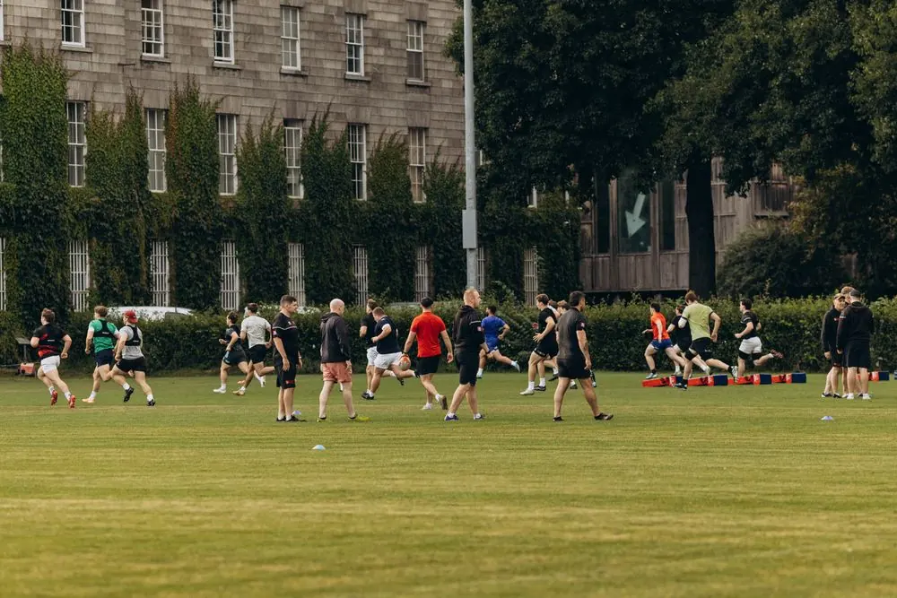 Students playing on a green university sports field