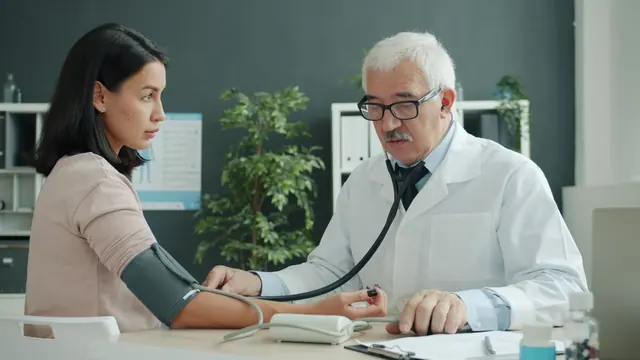 A doctor measuring a patient's blood pressure