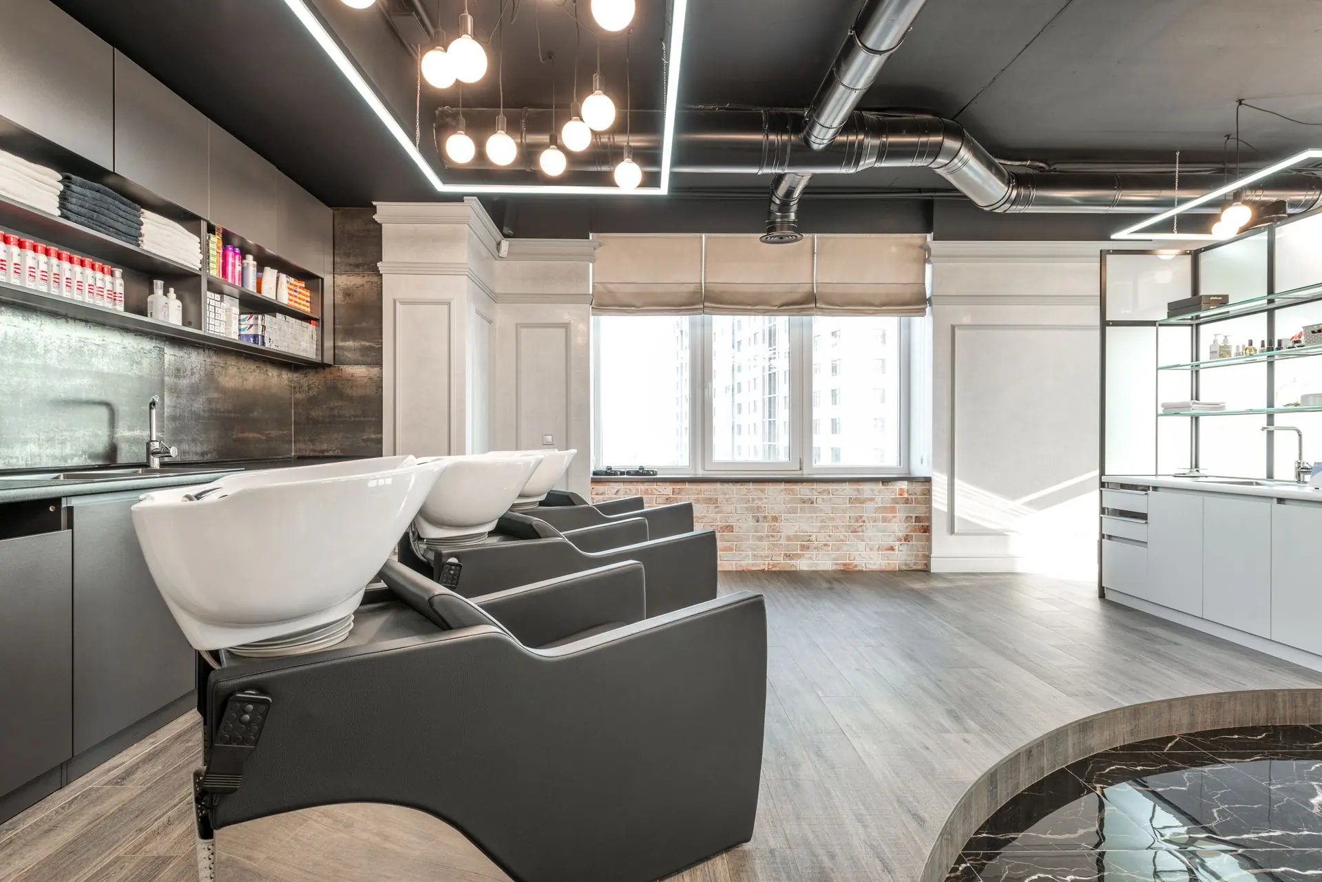 Salon interior with styling chairs, mirrors and a light-filled window