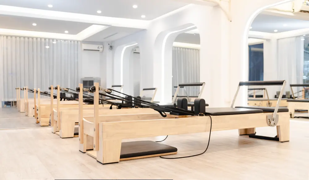 Pilates reformers arranged in a bright studio
