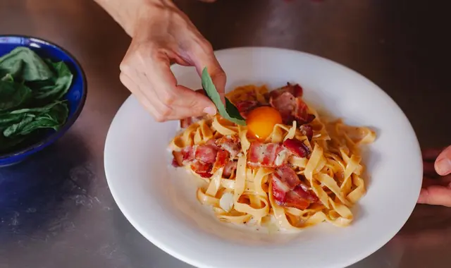 Hand-cut tagliatelle in a slow tomato sauce