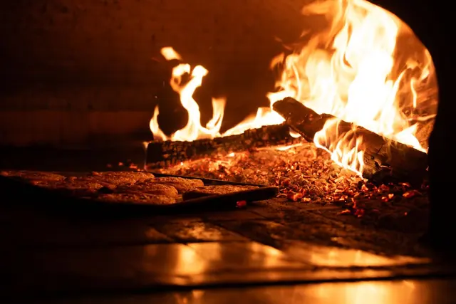 Flames burning inside a wood-fired oven