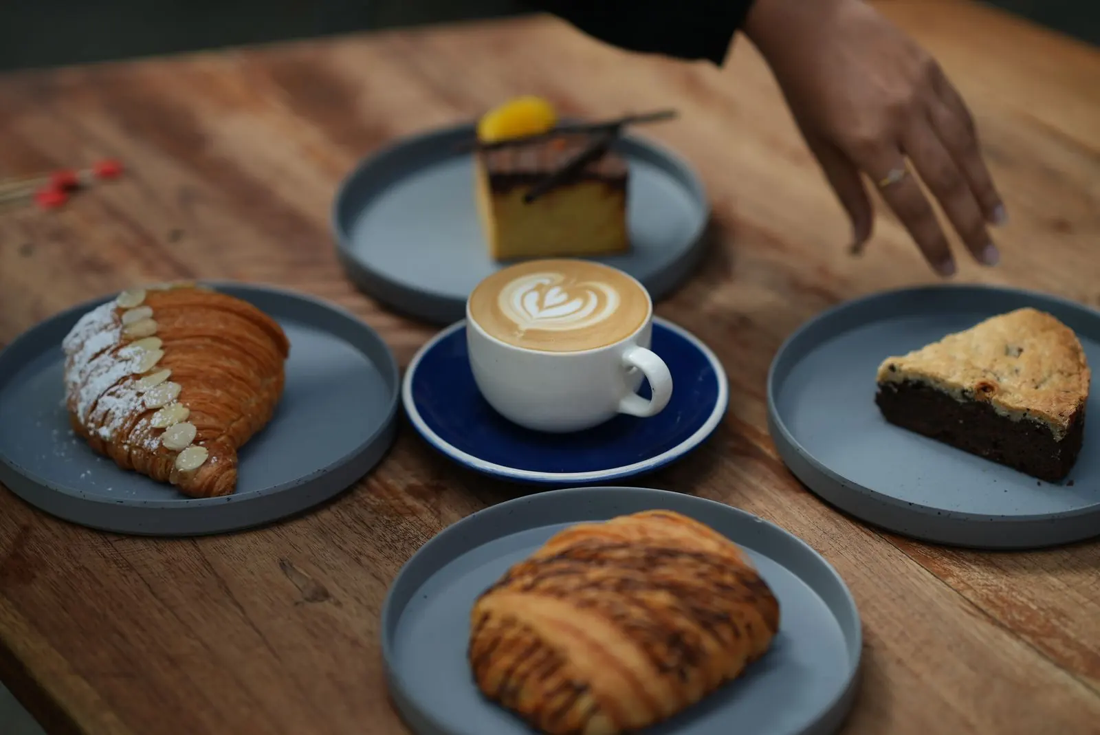 Coffee and a selection of pastries shared across a cafe table