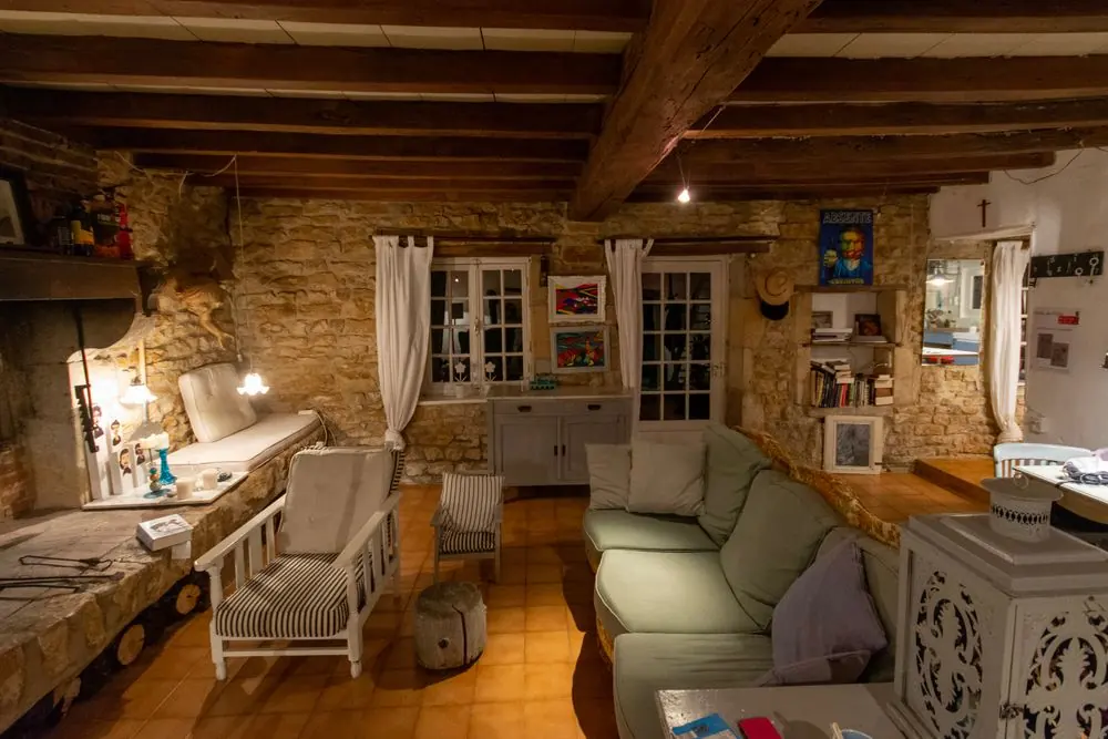 Rustic cottage sitting room with stone walls and soft seating