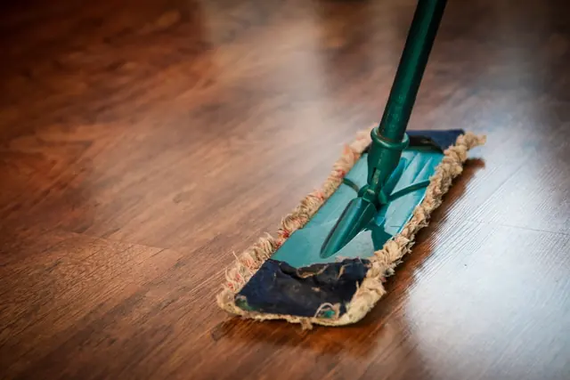 A flat mop gliding across a polished wooden floor