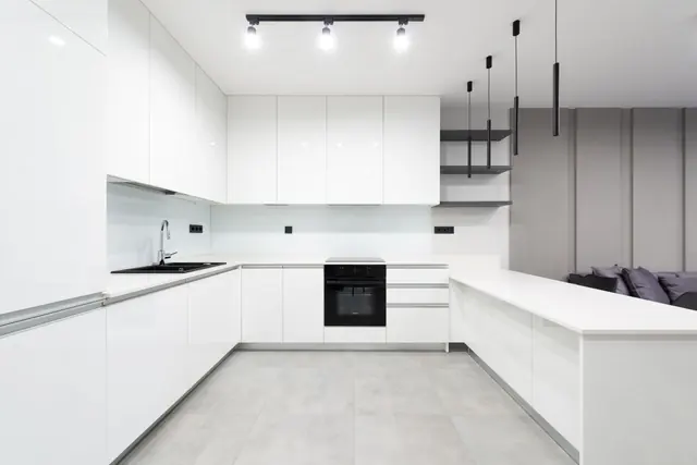 A bright white modern kitchen with clear countertops