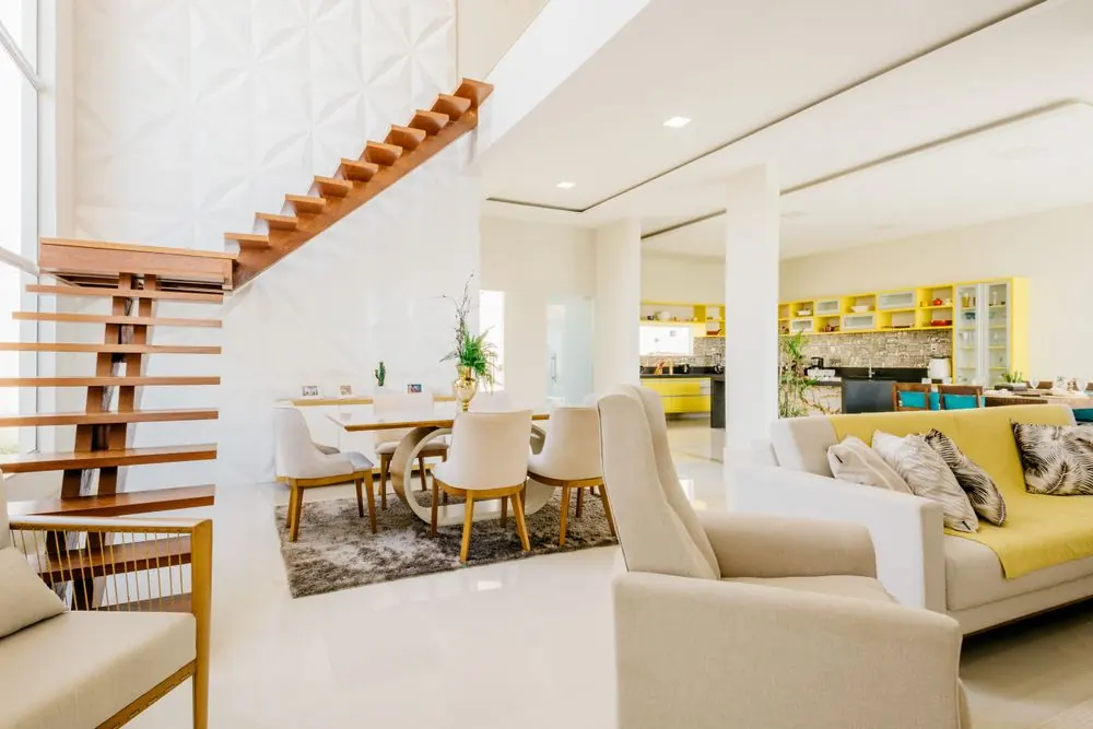 Bright living room with seating and a wooden staircase