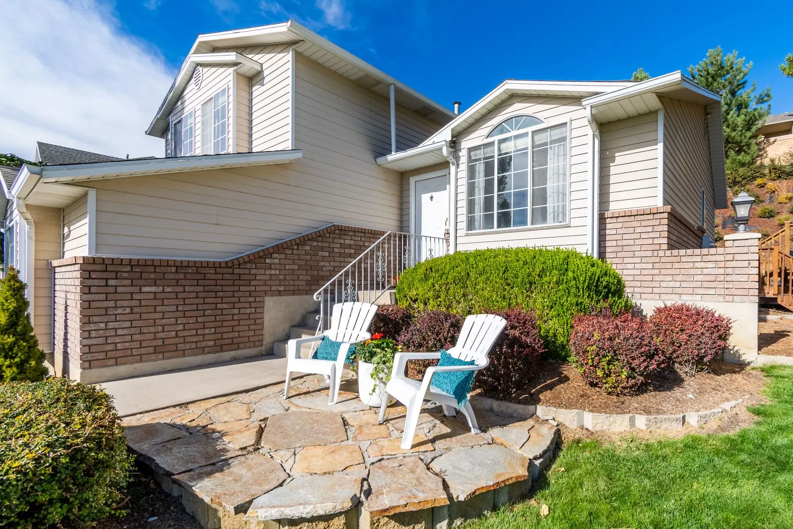 Maintained home exterior with a porch and garden planting