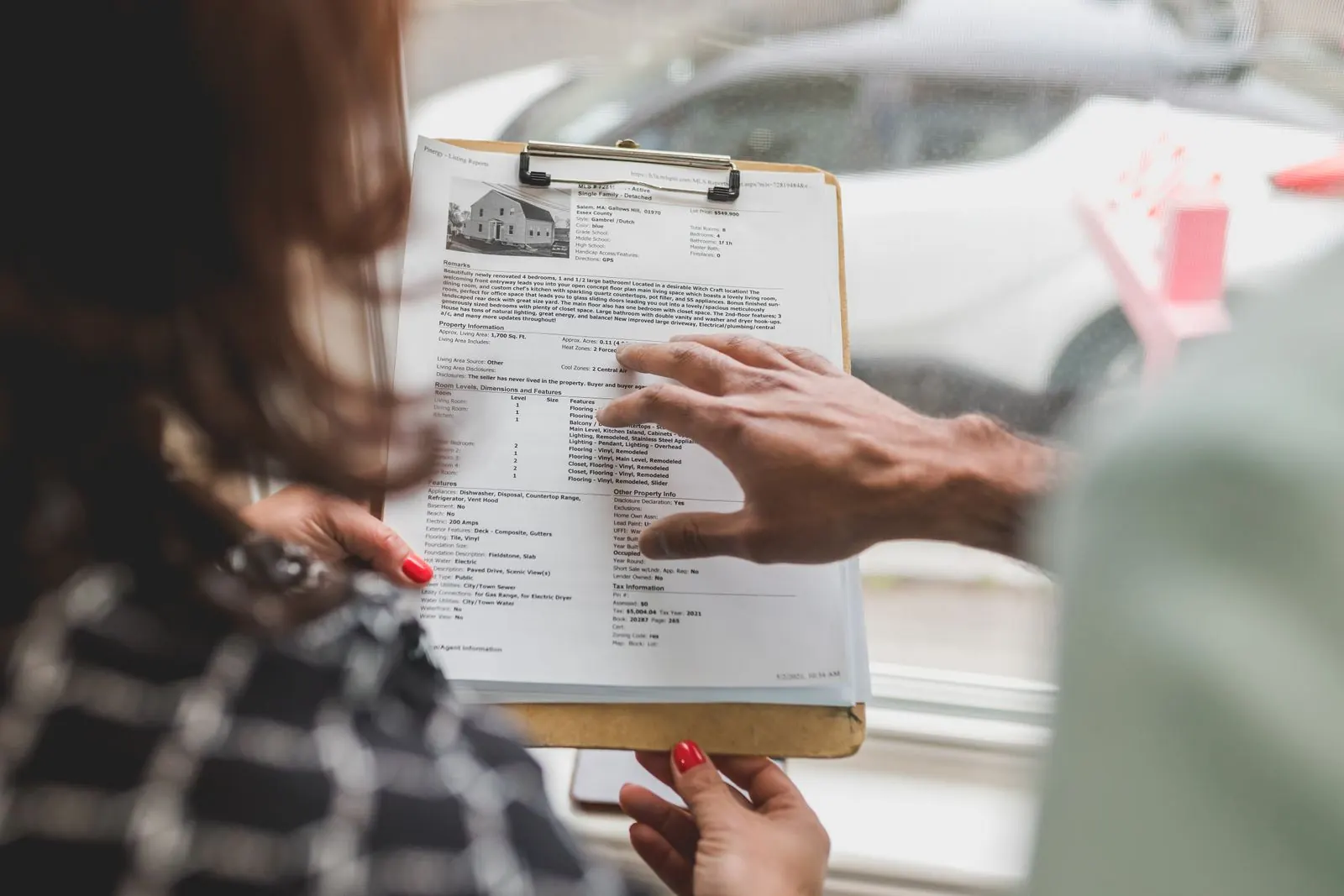 Close view of a clipboard during a property inspection discussion