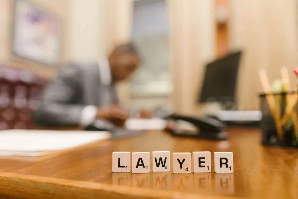 Law-themed desk detail with letter tiles in a softly focused office