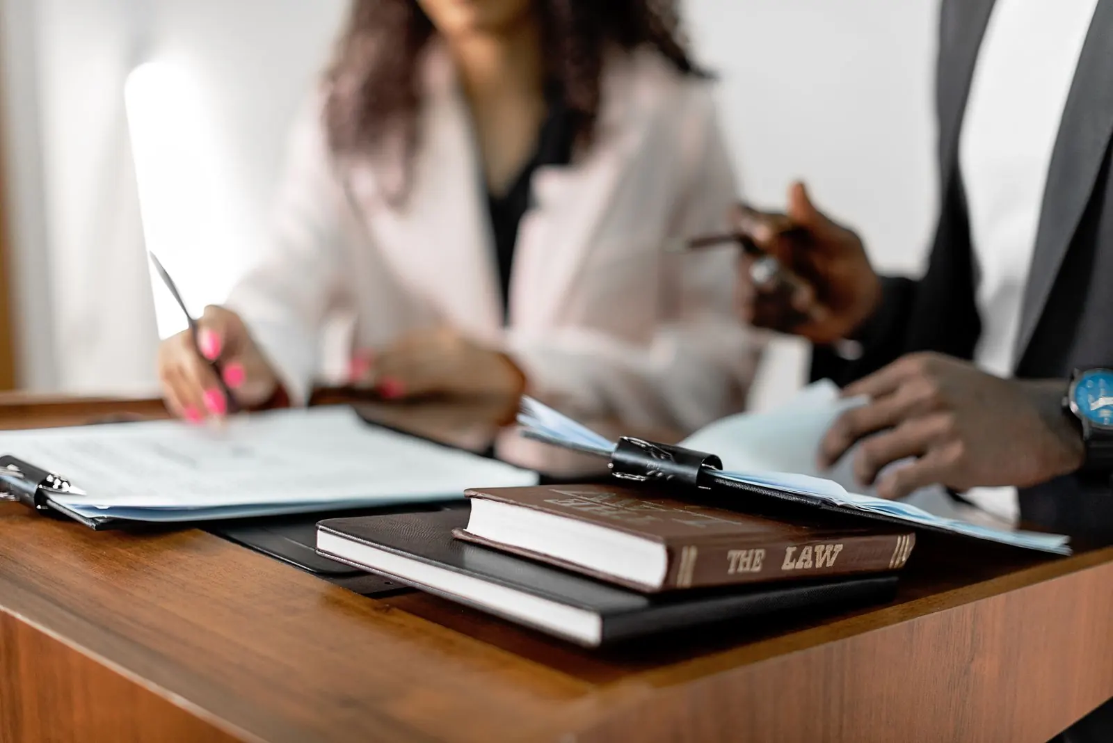 Close view of legal reference material and a discussion at a desk