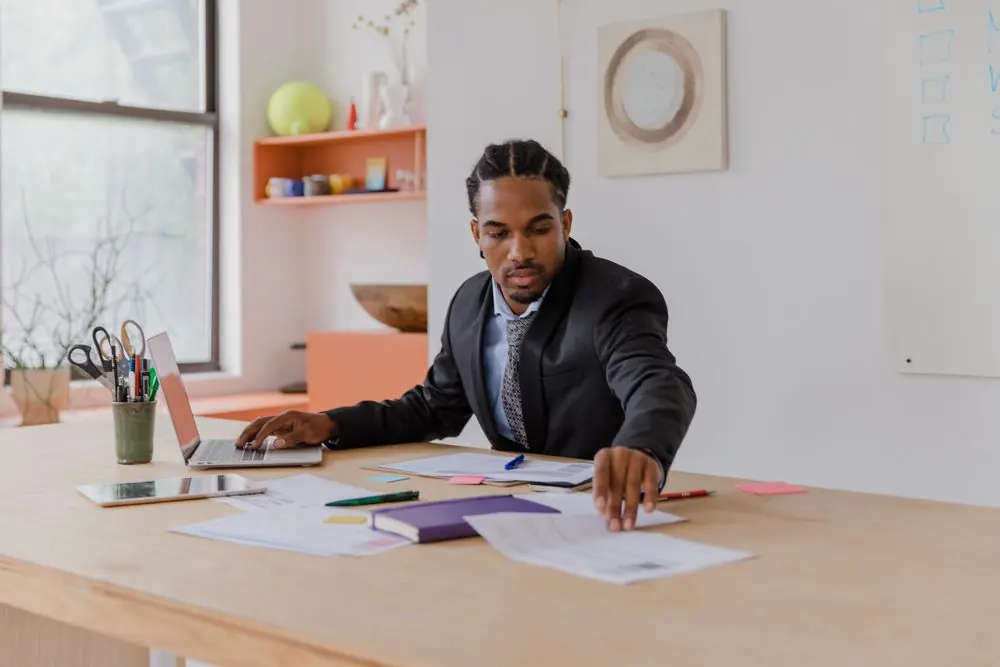 Business owner reviewing a plan at a bright office desk