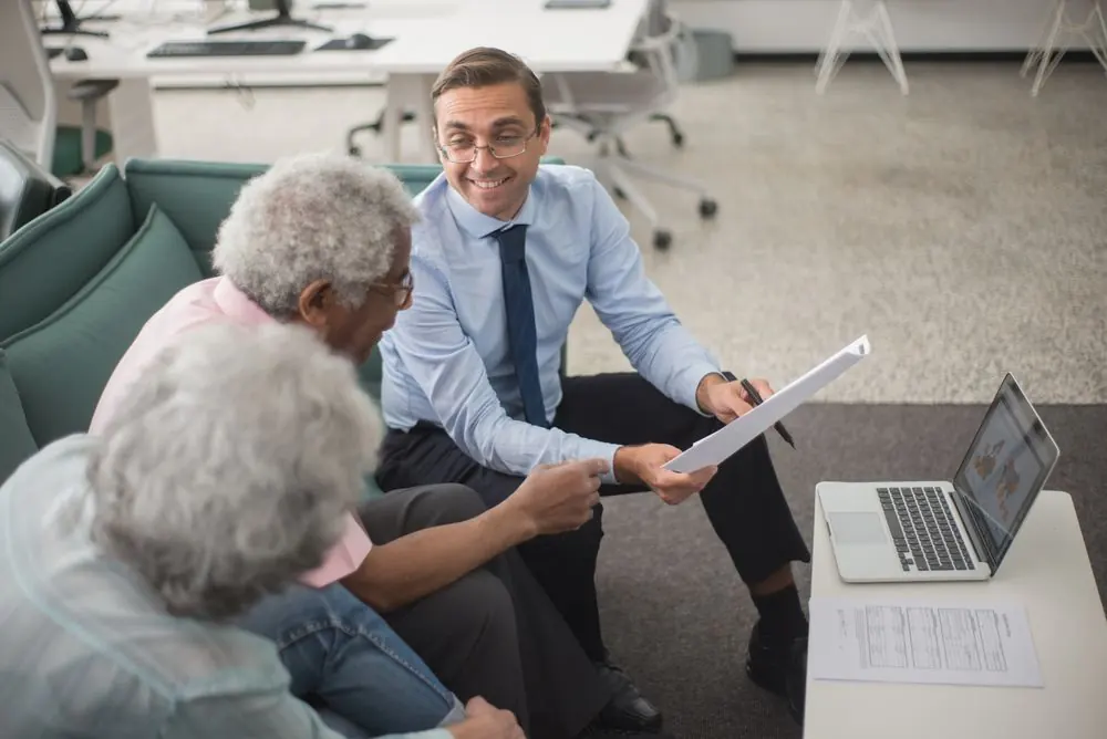 Adviser explaining paperwork to an older couple